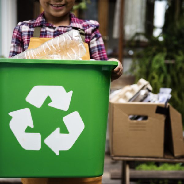 African Descent Kid Holding Recycling Box of Plastic Bottles